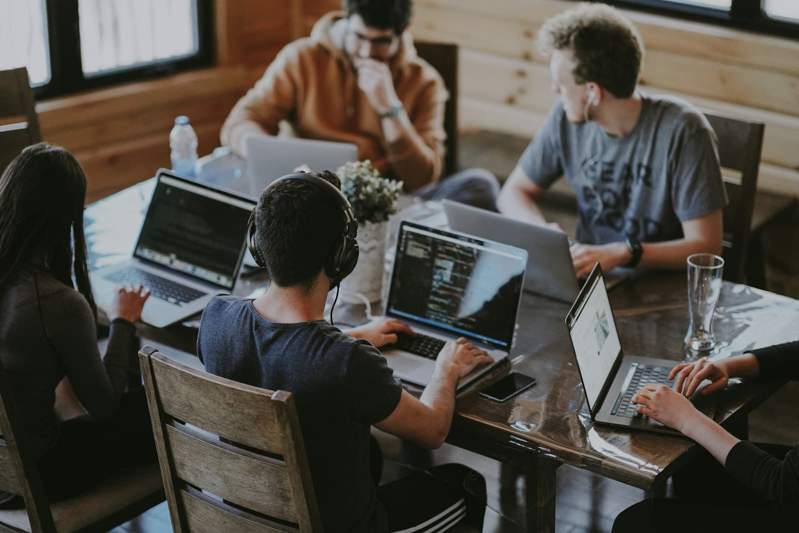 A team collaborating on laptops around a shared table